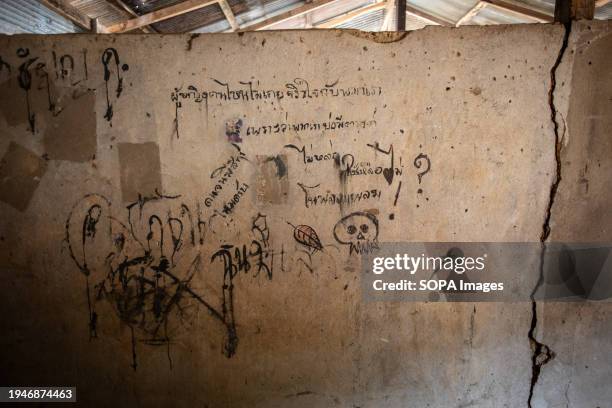 Graffiti inside the "Training Soldier's House". "Khun Sa Old Camp", the former northern Thailand base of ethnic Chinese drug lord and warlord "Khun...