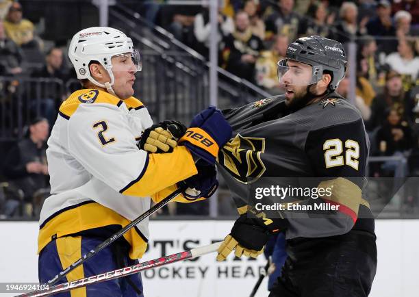 Luke Schenn of the Nashville Predators grabs the jersey of Michael Amadio of the Vegas Golden Knights in the second period of their game at T-Mobile...