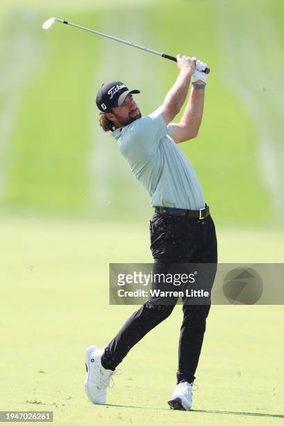 Cameron Young of the United States plays his second shot on the first hole during Round Three of the Hero Dubai Desert Classic at Emirates Golf Club...