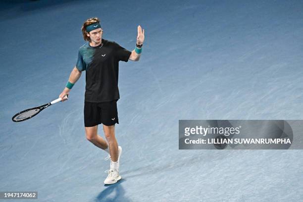 Russia's Andrey Rublev reacts on a point against Italy's Jannik Sinner during their men's singles quarter-final match on day 10 of the Australian...