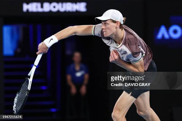 Italy's Jannik Sinner serves against Russia's Andrey Rublev during their men's singles quarter-final match on day 10 of the Australian Open tennis...