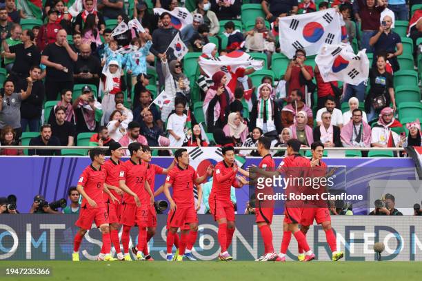 Son Heung-min of South Korea celebrates with teammates after scoring his team's first goal during the AFC Asian Cup Group E match between Jordan and...