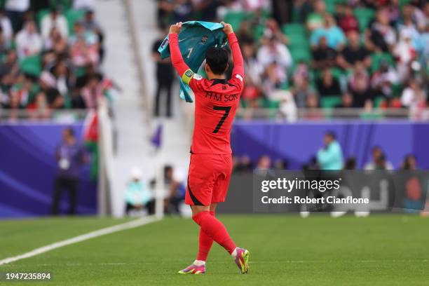 Son Heung-min of South Korea celebrates scoring his team's first goal from the penalty spot during the AFC Asian Cup Group E match between Jordan and...