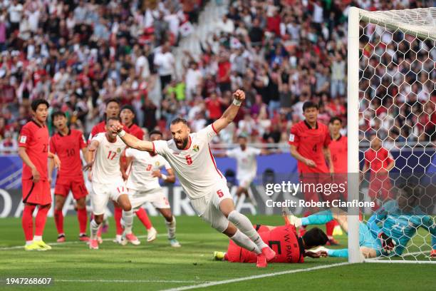 Yazan Al-Arab of Jordan celebrates after Park Yong-woo of South Korea scores an own goal during the AFC Asian Cup Group E match between Jordan and...