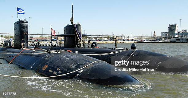 The USS Newport News secures itself next to its sister Los Angeles-class submarine USS Boise after returning to Norfolk Naval Station in Norfolk,...