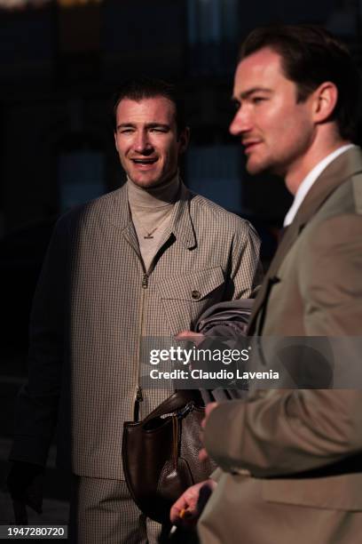 Scott Staniland wears beige turtleneck top, beige checked jacket with matching trousers, and Twins Brett Staniland wears white shirt, brown sweater,...