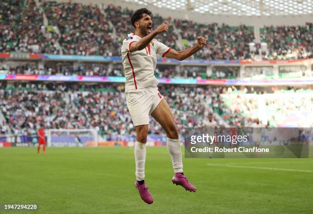 Yazan Al-Naimat of Jordan celebrates scoring his team's second goal during the AFC Asian Cup Group E match between Jordan and South Korea at Al...