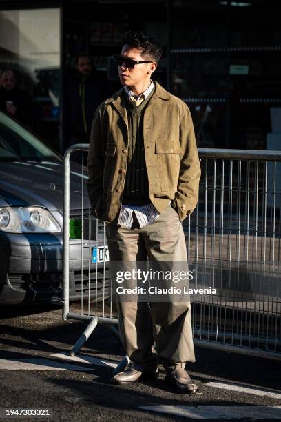 Cheng Chang Fan wears green jumper, beige pants, olive green jacket, taupe loafers, outside Paul Smith, during the Menswear Fall/Winter 2024/2025 as...