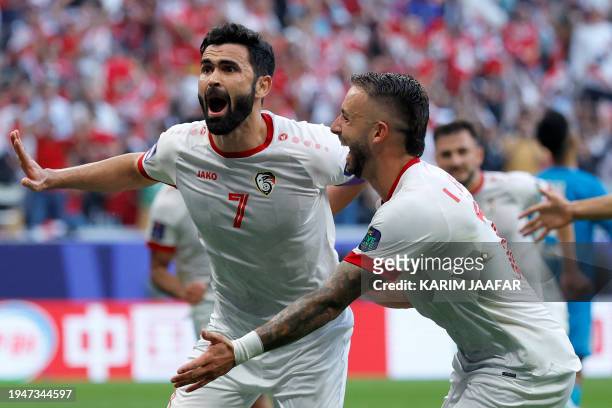 Syria's forward Omar Khribin celebrates after scoring his team's first goal during the Qatar 2023 AFC Asian Cup Group B football match between Syria...