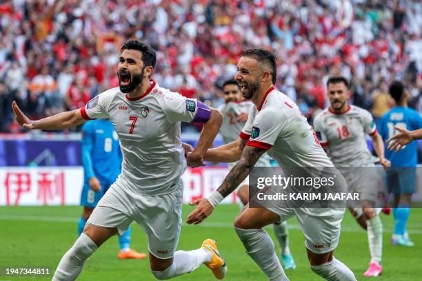 Syria's forward Omar Khribin celebrates after scoring his team's first goal during the Qatar 2023 AFC Asian Cup Group B football match between Syria...