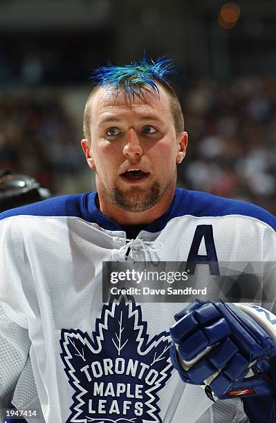 Bryan McCabe of the Toronto Maple Leafs loses his helmet showing off his blue dyed mohawk against the Philadelphia Flyers in game four of the first...