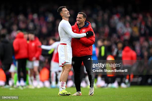 Gabriel Martinelli of Arsenal celebrates with teammate Cedric Soares following the team's victory during the Premier League match between Arsenal FC...