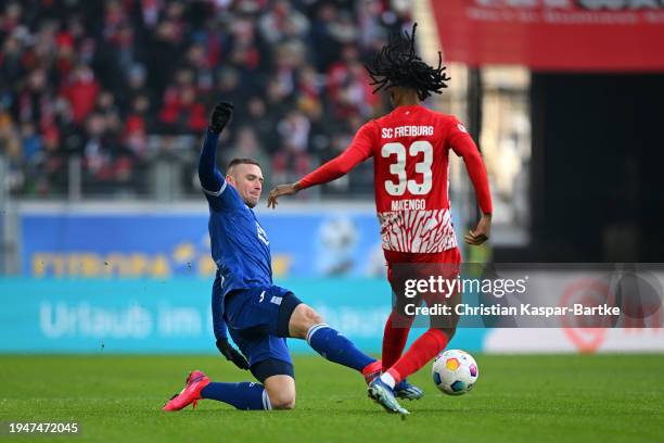 Pavel Kaderabek of TSG 1899 Hoffenheim challenges Jordy Makengo of Sport-Club Freiburg during the Bundesliga match between Sport-Club Freiburg and...