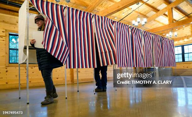 Voter leave a voting booth at The Barn at Bull Meadow in Concord, New Hampshire, during voting for the New Hampshire Primary on January 23, 2024....