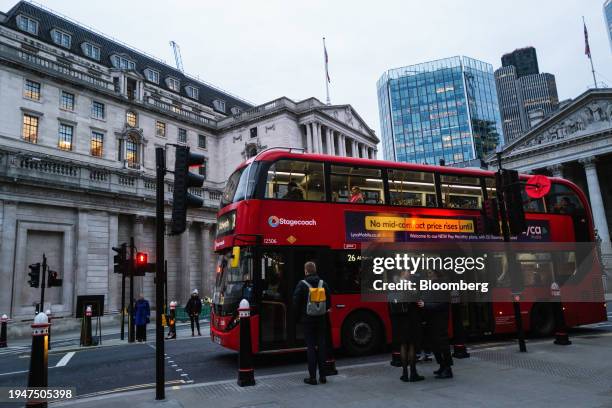 Commuters pass the Bank of England in the City of London, UK, on Tuesday, Jan. 23, 2024. The Bank of England is being urged to end its bias toward...