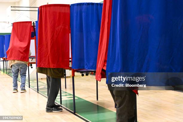 Voters cast their ballots at a polling station inside Hillside Middle school in Manchester, New Hampshire, US, on Tuesday, Jan. 23, 2024. New...