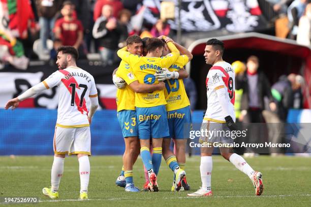 Sergi Cardona of UD Las Palmas celebrates their victory with teammates Maximo Perrone and Mika Marmol as Radamel Falcao of Rayo Vallecano de Madrid...