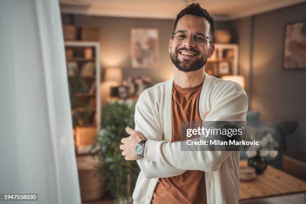 portrait of confident and happy young man at home - só um homem jovem imagens e fotografias de stock