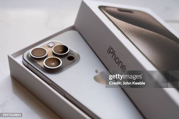 In this photo illustration a brand new Apple iPhone 15 pro titanium is displayed with box and packaging on January 20, 2024 in Leigh, United Kingdom.