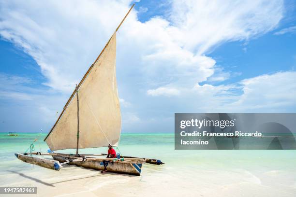 traditional sailing boat on the shore, zanzibar - dhow stock pictures, royalty-free photos & images