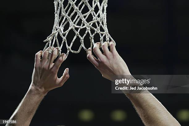 Greg Ostertag of the Utah Jazz hangs from the basketball net in Game one of the Western Conference Quarterfinals against the Sacramento Kings during...