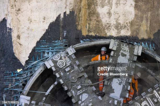 Workers behind the cutterhead of tunnel boring machine Lydia after breaking through a concrete wall as it completes the construction of the Atlas...
