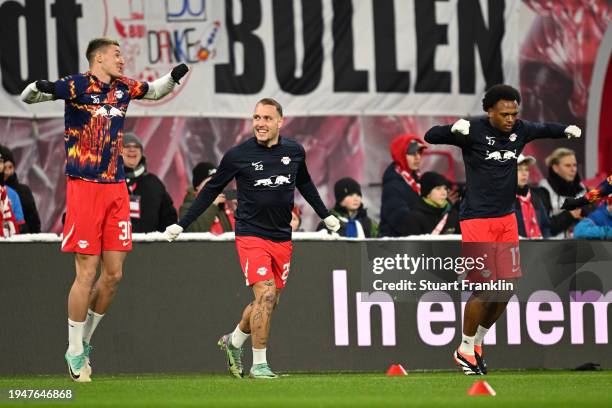 Benjamin Sesko, David Raum and Lois Openda of RB Leipzig warm up prior to the Bundesliga match between RB Leipzig and Bayer 04 Leverkusen at Red Bull...