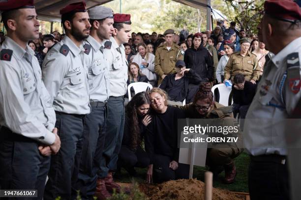 The mother of Israeli soldier Ilay Levy mourns during his funeral at the military cemetery in Tel Aviv, on January 23 after he was killed in combat...