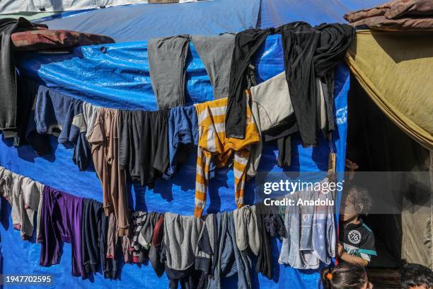 Palestinians who took refuge in Rafah carry on with their daily lives in makeshift tents among the wreck and rubble of buildings destroyed by Israeli...