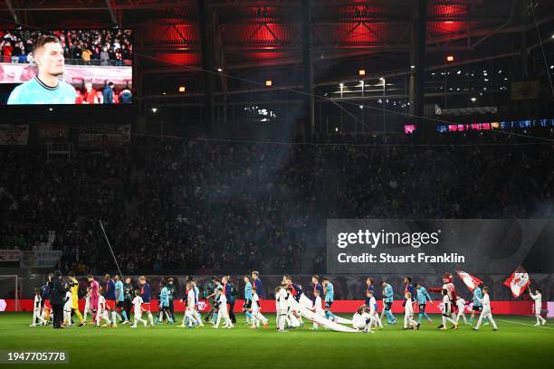 General view inside the stadium as the players and match officials walk out onto the pitch prior to the Bundesliga match between RB Leipzig and Bayer...