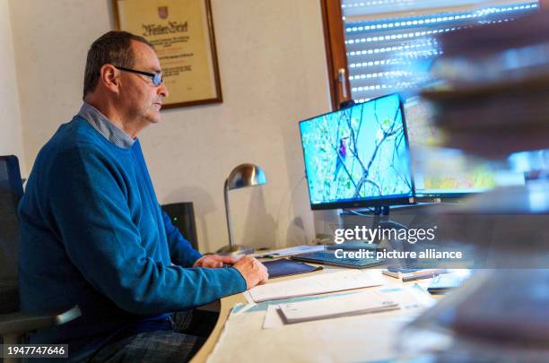 January 2024, Hesse, Niddatal: Michael Schneller, Wetterau district farmer and farmer from Erlenhof, sits at his desk in his office. Farmer Michael...