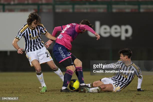 Samuele Damiani and Martin Palumbo of Juventus clash with Federico Marchesi of Rimini FC during the Serie C match between Juventus Next Gen and...