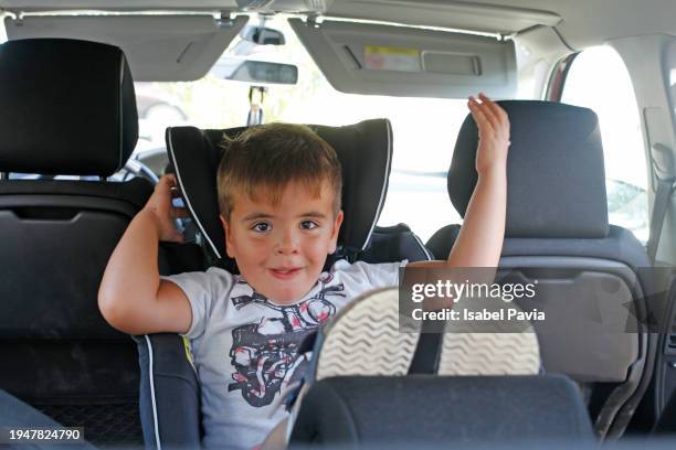 boy sitting in car - car back seat stock pictures, royalty-free photos & images