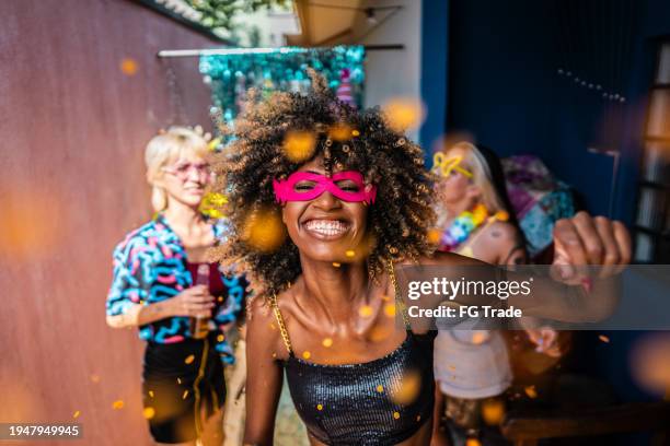 portrait of a young woman enjoying carnival with friends at home - party bildbanksfoton och bilder