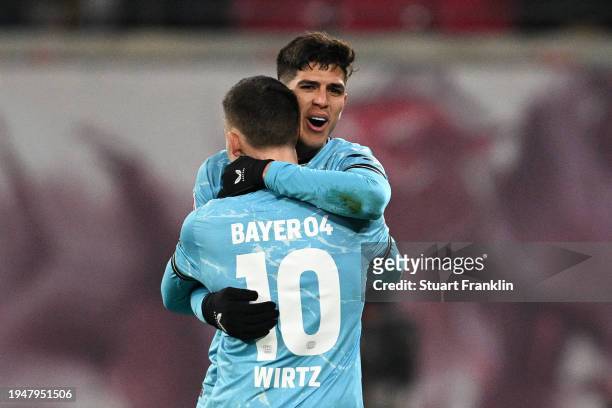 Piero Hincapie of Bayer Leverkusen celebrates scoring his team's third goal with teammate Florian Wirtz during the Bundesliga match between RB...