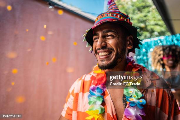 young man enjoying carnival at home - fiestas stock pictures, royalty-free photos & images