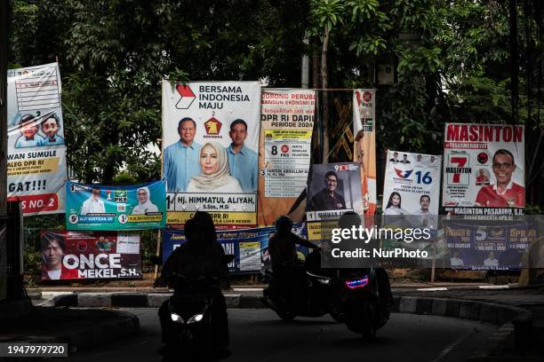 Motorist is riding past banners for political parties installed along the street in Jakarta, Indonesia, on January 23, 2024. The world's...
