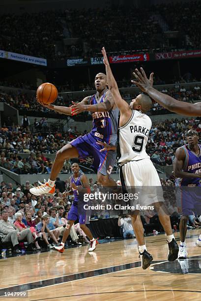 Stephon Marbury of the Phoenix Suns drives to the basket against Tony Parker of the San Antonio Spurs in Game one of the Western Conference...