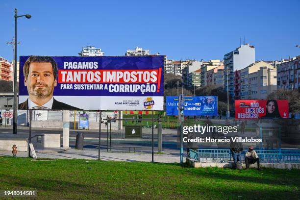 Chega! far-right political party billboard campaign poster, showing a portrait of its leader André Ventura, is seen in front of CDU and Bloco de...