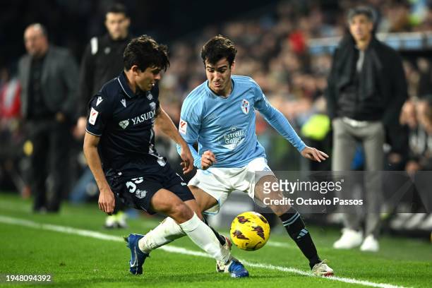 Manu Sanchez of Celta Vigo is challenged by Alberto Dadie of Real Sociedad during the LaLiga EA Sports match between Celta Vigo and Real Sociedad at...