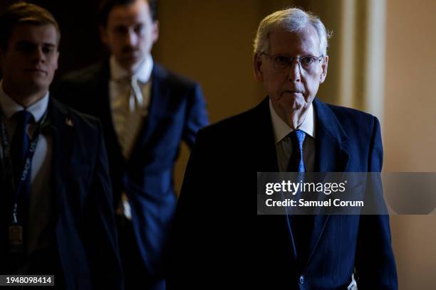 Senate Minority Leader Mitch McConnell walks towards the Senate floor from his office on January 23, 2024 in Washington, DC. Negotiations over border...