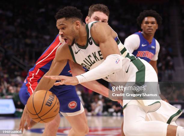 Giannis Antetokounmpo of the Milwaukee Bucks drives around Mike Muscala of the Detroit Pistons during the first half at Little Caesars Arena on...