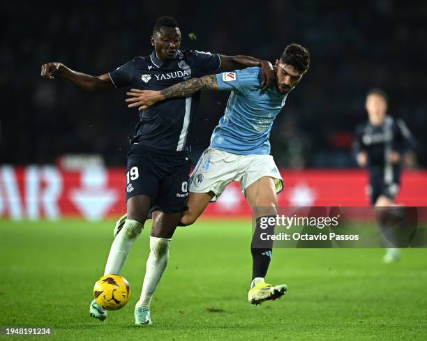 Umar Sadiq of Real Sociedad is challenged by Unai Nunez of Celta Vigo during the LaLiga EA Sports match between Celta Vigo and Real Sociedad at...