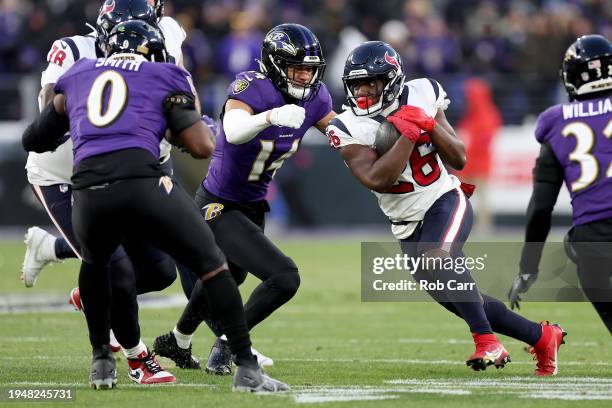 Devin Singletary of the Houston Texans runs with the ball against the Baltimore Ravens during the first quarter in the AFC Divisional Playoff game at...