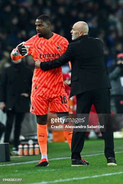 Mike Maignan of AC Milan reacts towards the fourth official alongside Stefano Pioli, Head Coach of AC Milan, during the Serie A TIM match between...