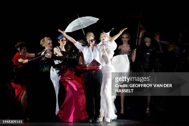 French designer Julien Fournie celebrates with models after his show during the Women's Haute-Couture Spring/Summer 2024 Fashion Week in Paris on...