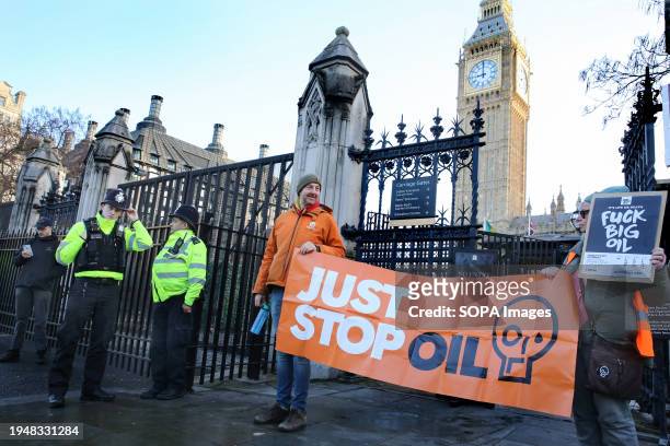 Protesters hold up placards and stand behind a "Just Stop Oil" banner during the demonstration. Environmental protesters have congregated outside the...