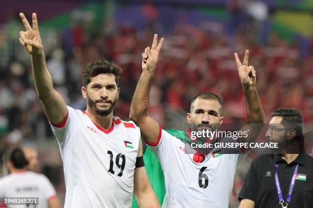 Palestine's forward Mahmoud Wadi amd Palestine's midfielder Oday Kharoub greet supporters after the Qatar 2023 AFC Asian Cup Group C football match...