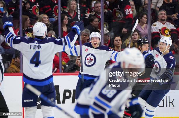 Nikolaj Ehlers of the Winnipeg Jets celebrates his overtime game winning goal against the Ottawa Senators with Neal Pionk at Canadian Tire Centre on...