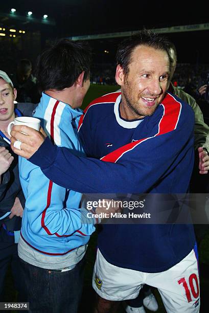 Portsmouth captain Paul Merson of Portsmouth celebrates his side winning promotion to the Premier League after the Nationwide League Division One...